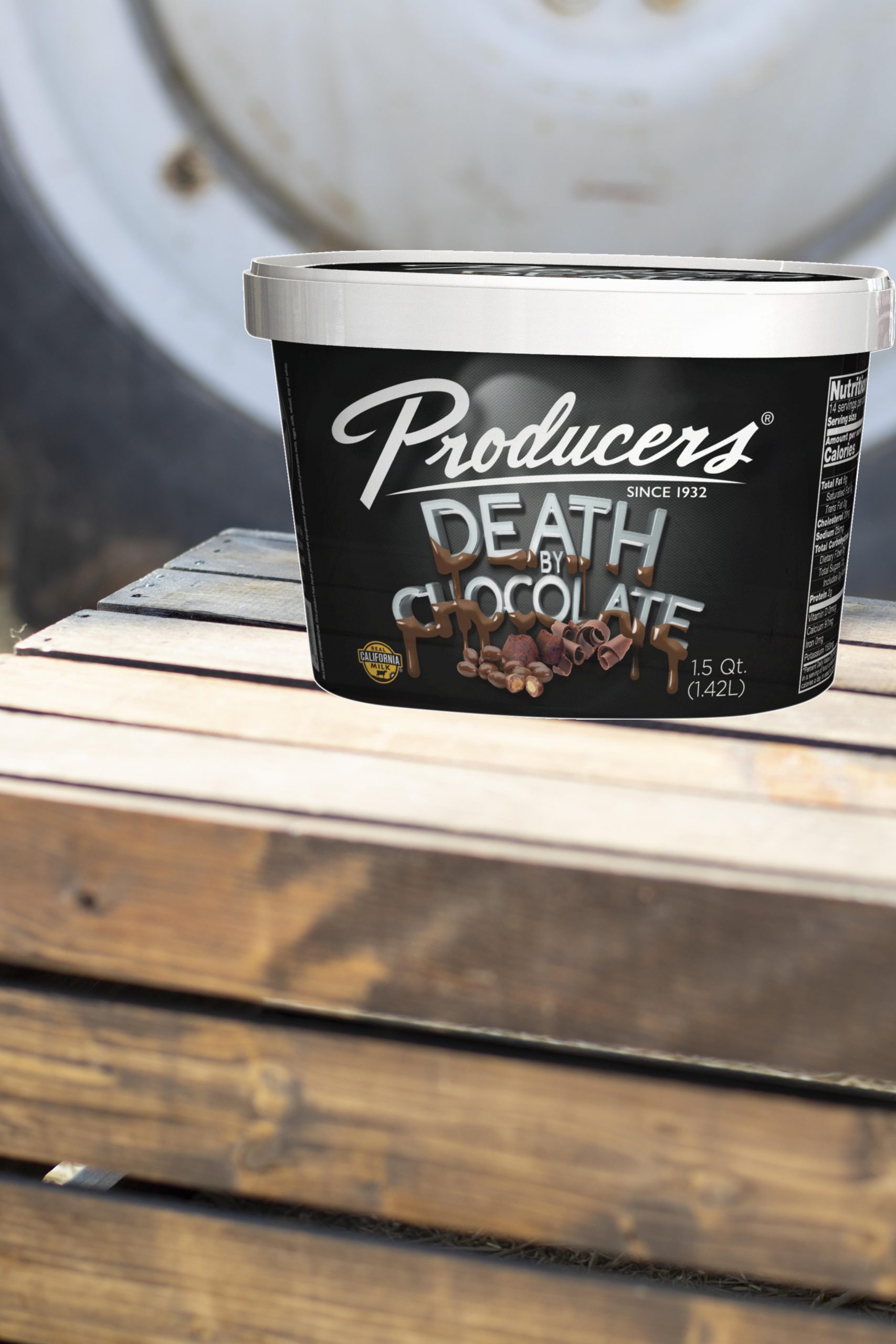 Death By Chocolate Producers Ice Cream sitting on wood in front of a tractor.