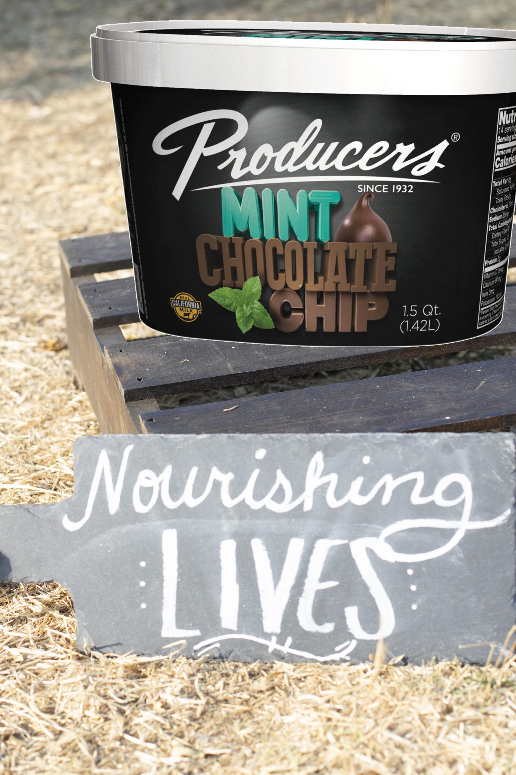 Mint Chocolate Chip Espresso Producers Ice Cream sitting on wood in the middle of a hay field.