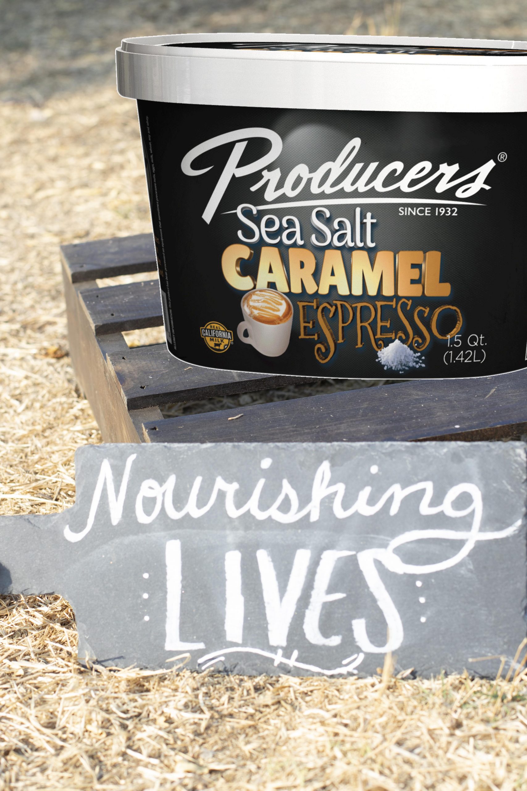 Sea Salt Caramel Espresso Producers Ice Cream sitting on wood in the middle of a hay field.
