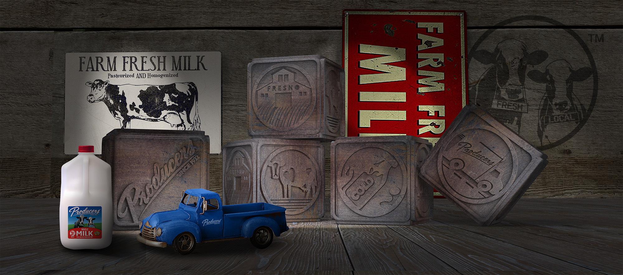 Milk labels and blocks are shown with a toy truck featuring the Producers Dairy logo